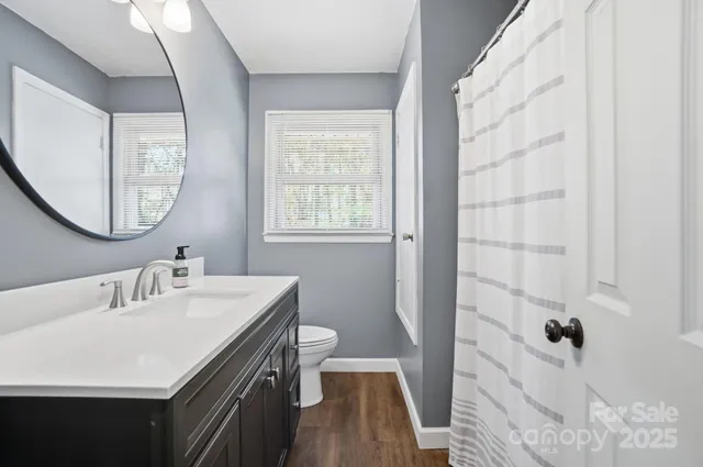 a en suite bathroom with a sink a mirror a vanity and a shower