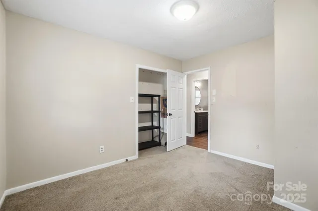 an empty room with closet and cabinet