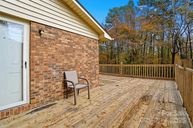 a view of balcony with wooden floor and fence