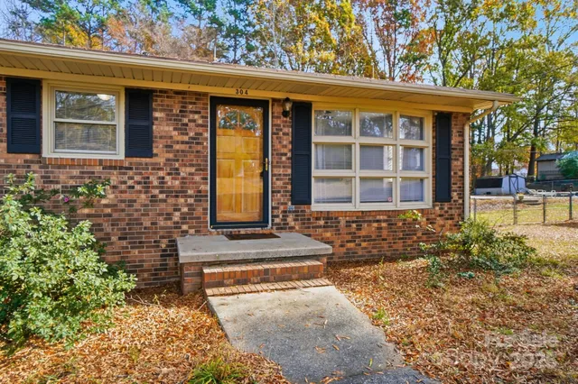 front view of a brick house with a large window