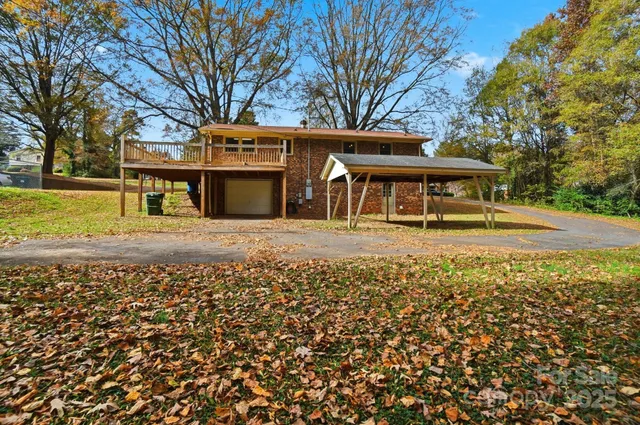 a view of a house with swimming pool next to a yard