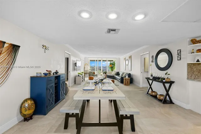 a living room with furniture and a mirror