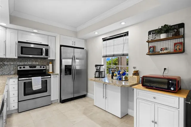 a kitchen with stainless steel appliances a stove a refrigerator and a sink