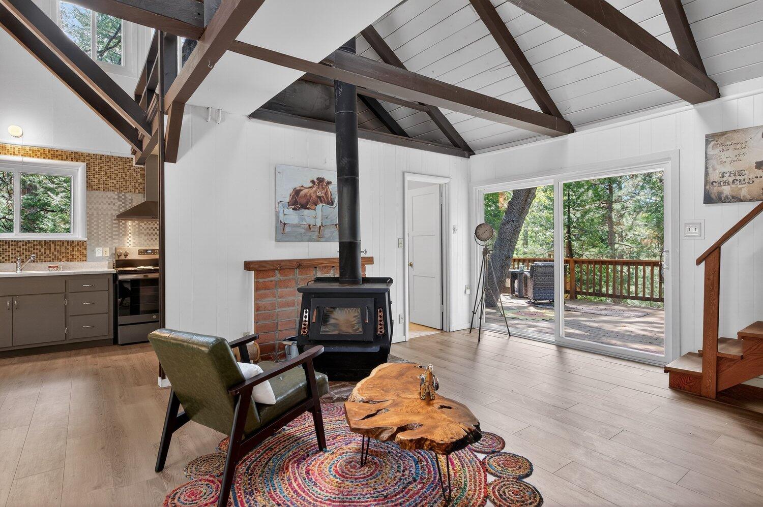 52230 Sylvan Way Idyllwild, CA 92549 - Photo 12 of 35 a living room with furniture a fireplace and a floor to ceiling window