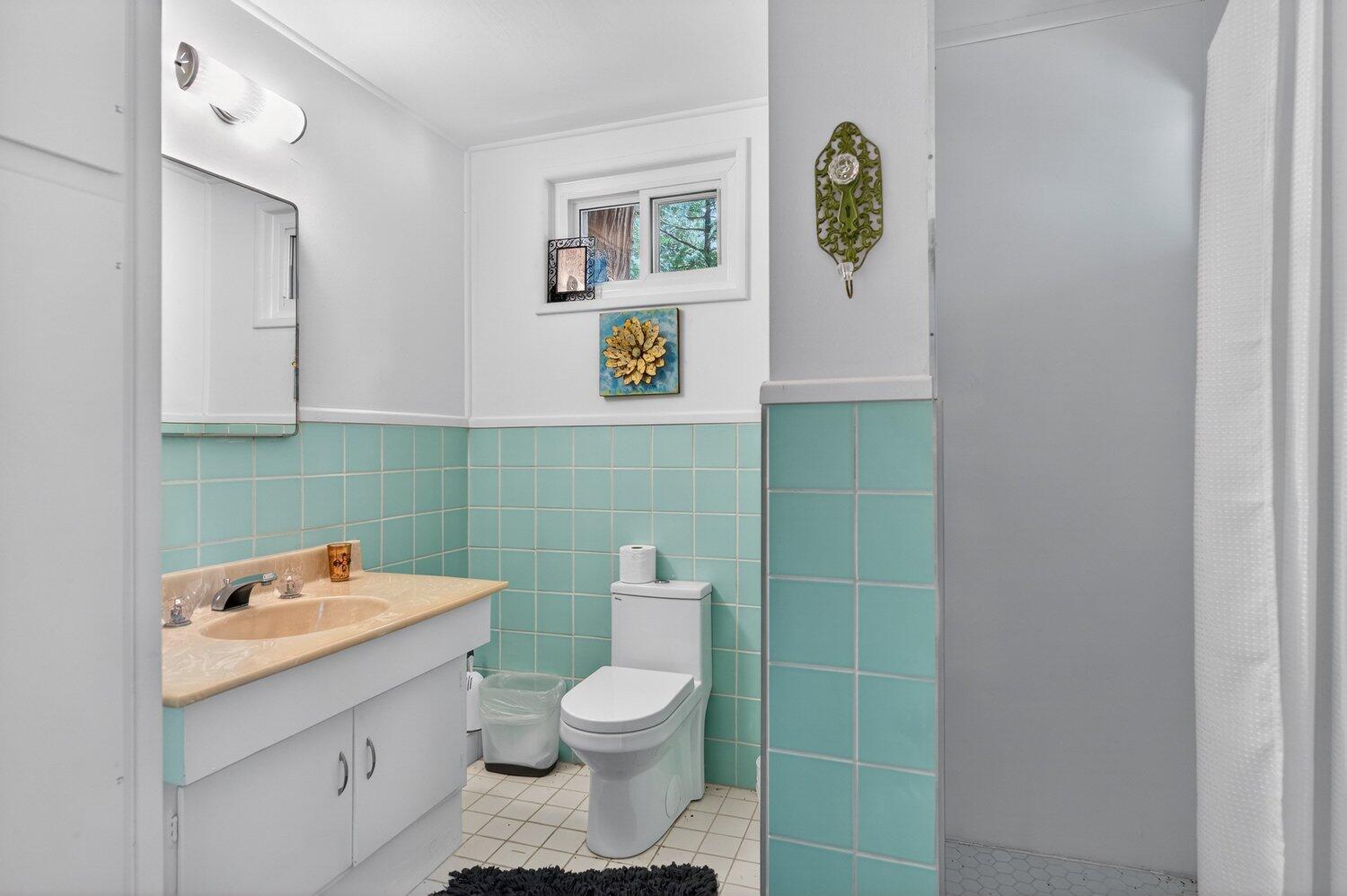 52230 Sylvan Way Idyllwild, CA 92549 - Photo 16 of 35 a bathroom with a toilet sink and mirror