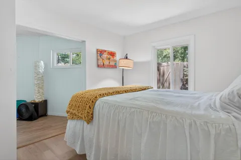 a bedroom with a bed and a window
