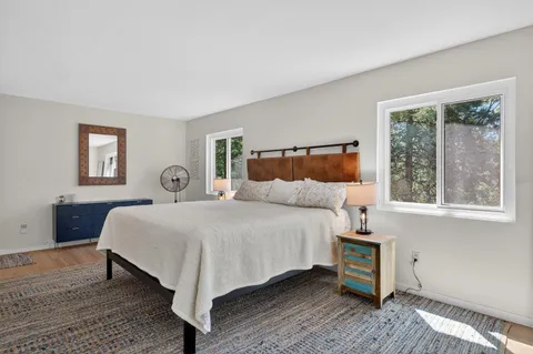 a large bedroom with a bed and window