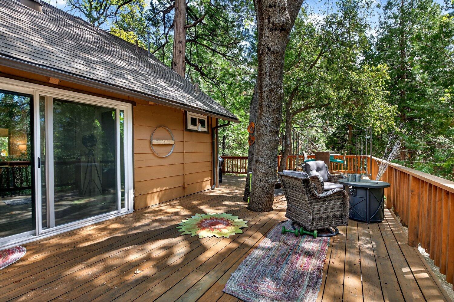 52230 Sylvan Way Idyllwild, CA 92549 - Photo 30 of 35 a backyard of a house with barbeque oven and outdoor seating