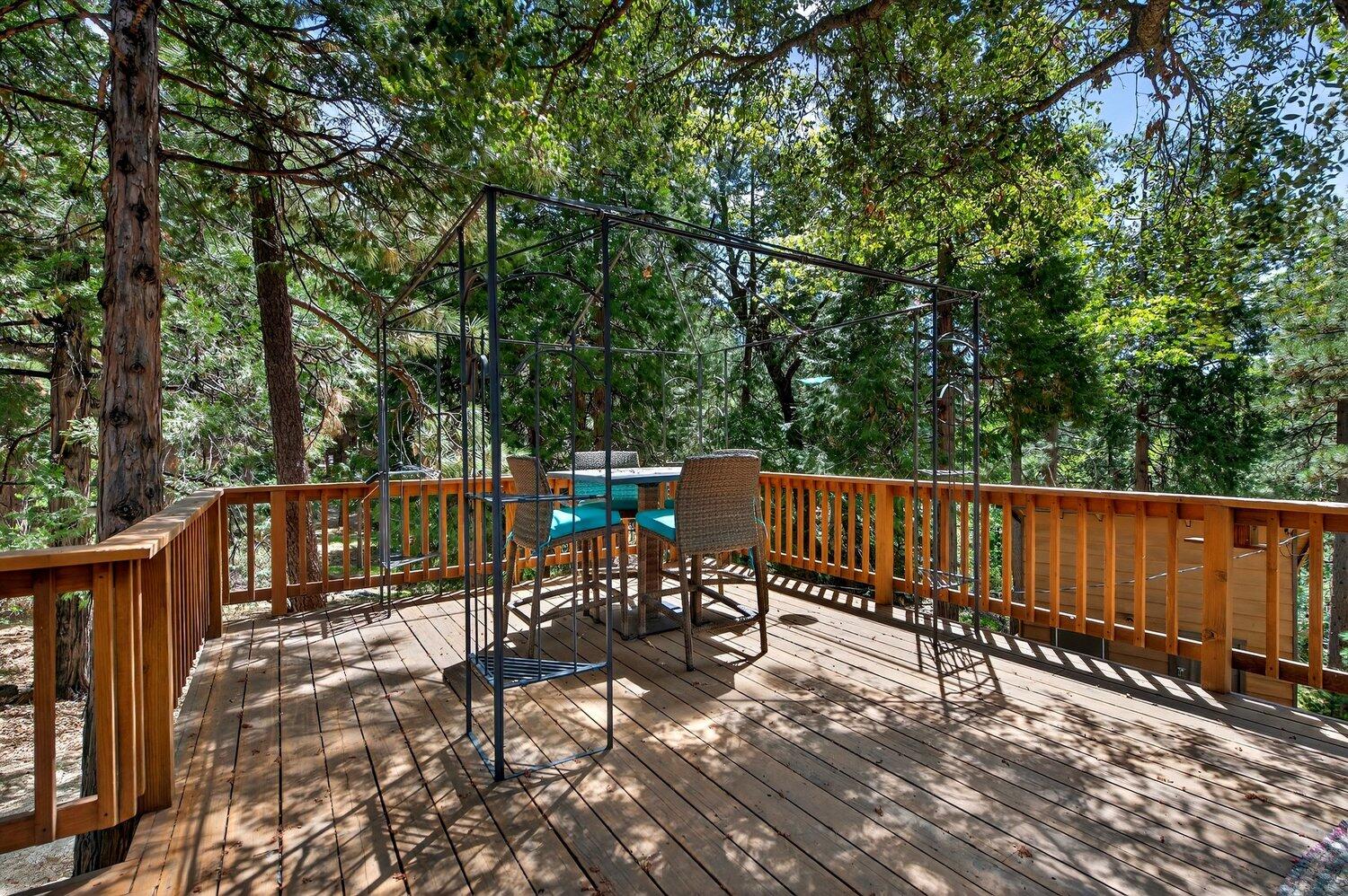 52230 Sylvan Way Idyllwild, CA 92549 - Photo 31 of 35 a view of a roof deck with wooden fence and trees