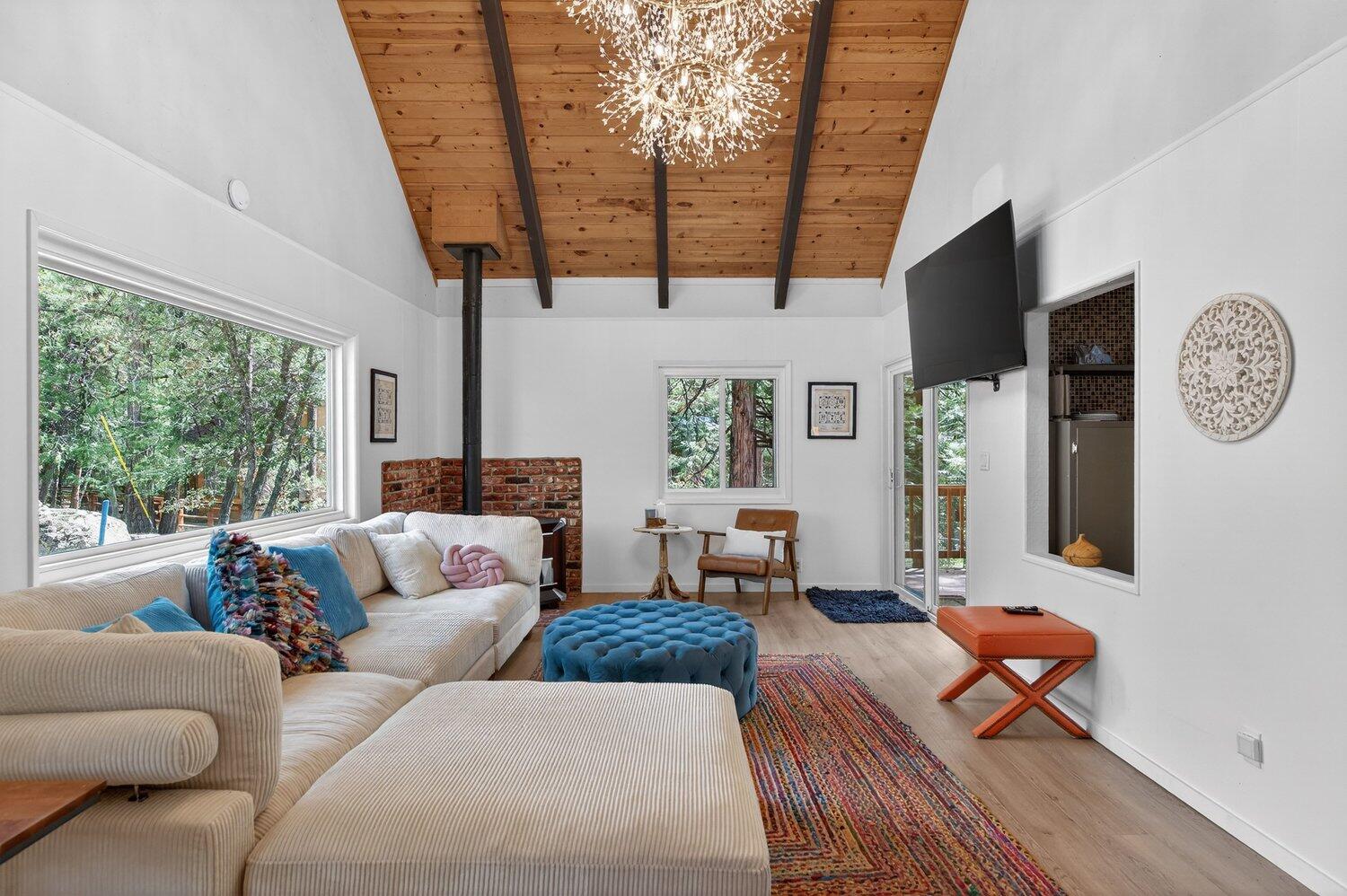 52230 Sylvan Way Idyllwild, CA 92549 - Photo 5 of 35 a living room with furniture a flat screen tv and a large window