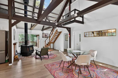 a view of a dining room with furniture wooden floor and a chandelier