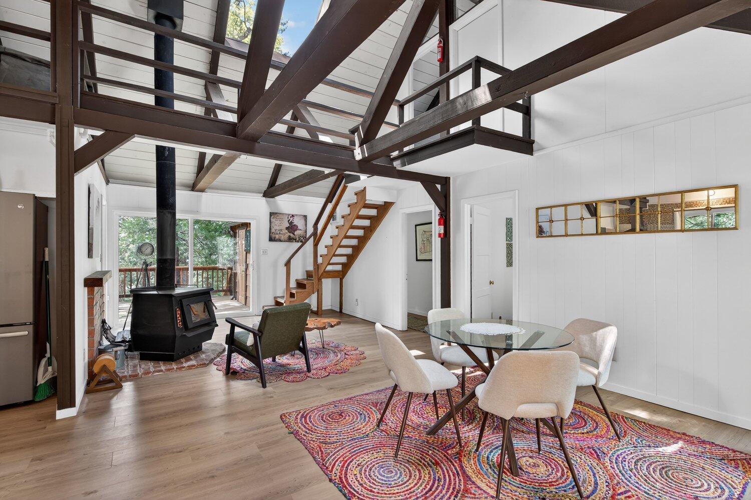 52230 Sylvan Way Idyllwild, CA 92549 - Photo 8 of 35 a view of a dining room with furniture wooden floor and a chandelier