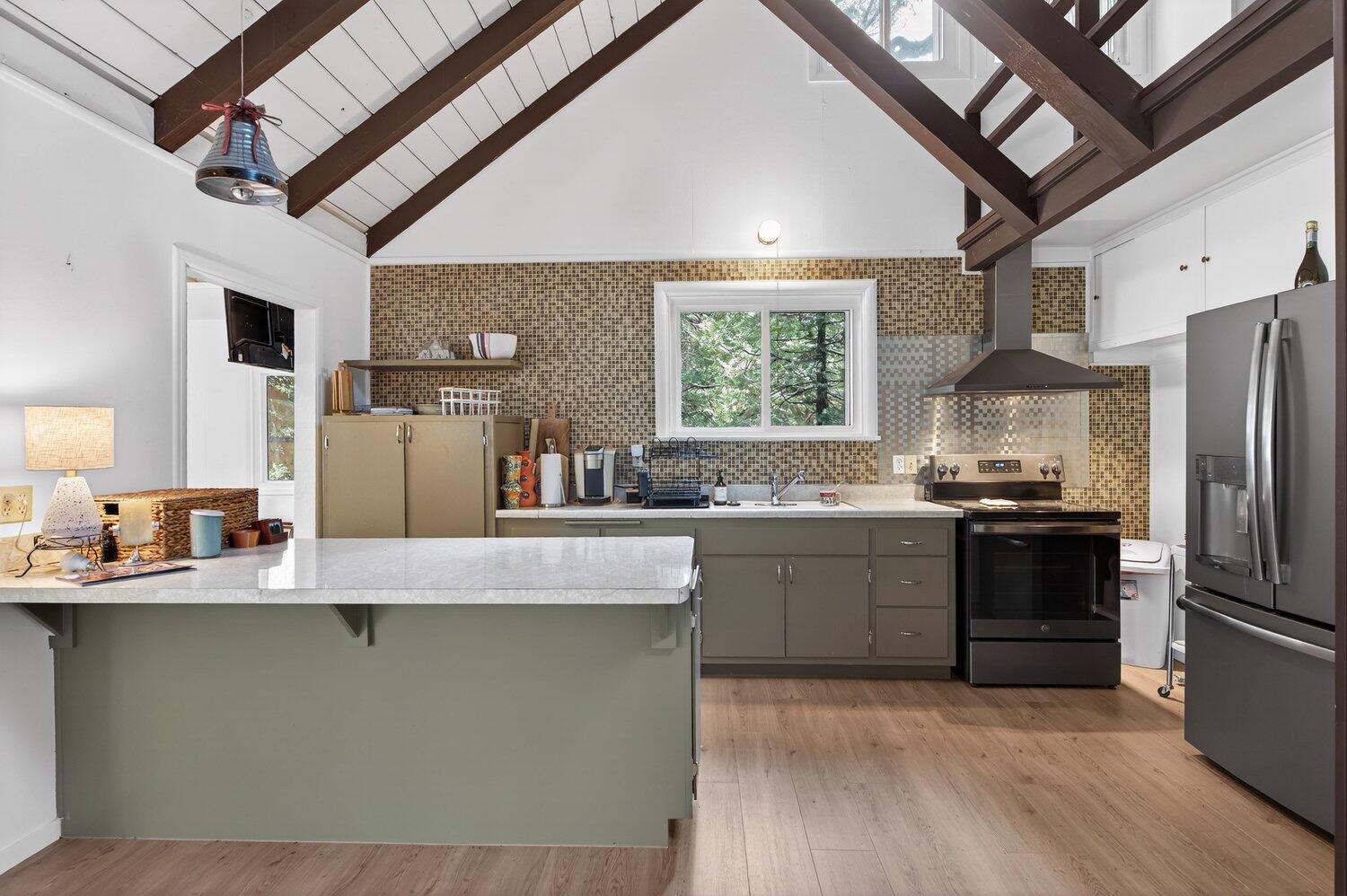52230 Sylvan Way Idyllwild, CA 92549 - Photo 10 of 35 a kitchen with stainless steel appliances granite countertop a sink a stove and a refrigerator