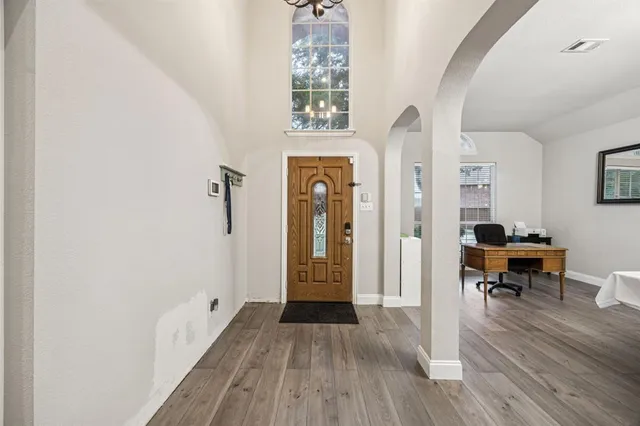 a view of a hallway view with wooden floor and furniture