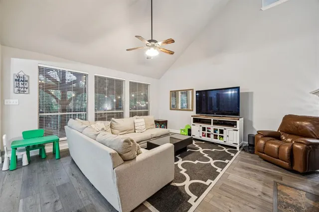 a living room with furniture and a flat screen tv
