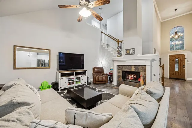 a living room with furniture a flat screen tv and a fireplace