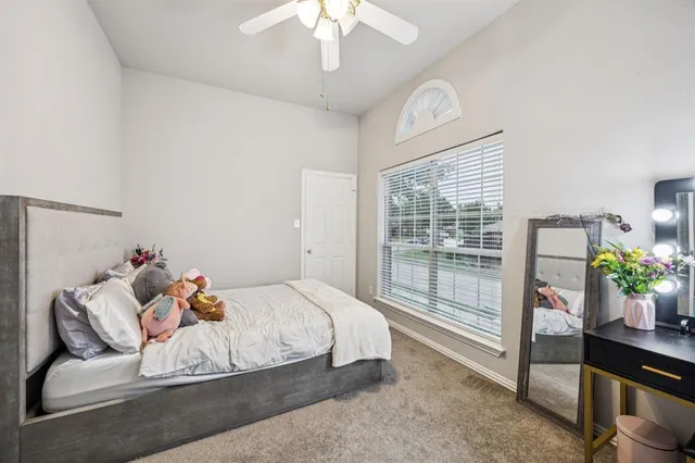 a bedroom with a bed and ceiling fan