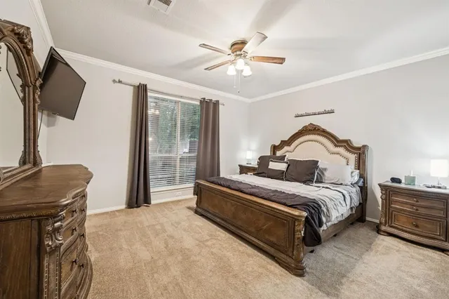 a spacious bedroom with a bed and flat screen tv