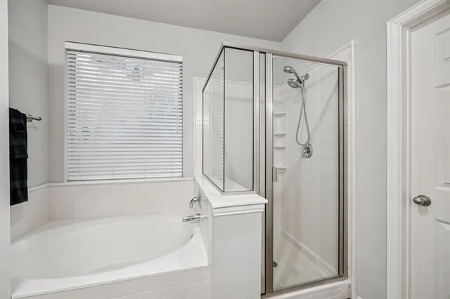 a bathroom with a bathtub and a shower