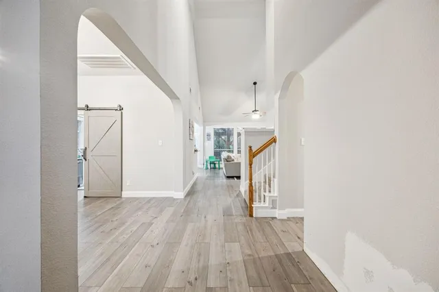 a view of a hallway view with wooden floor and staircase