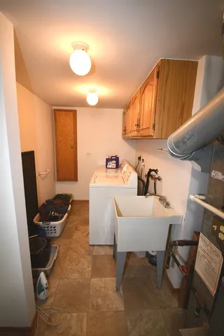a kitchen with a sink appliances and cabinets
