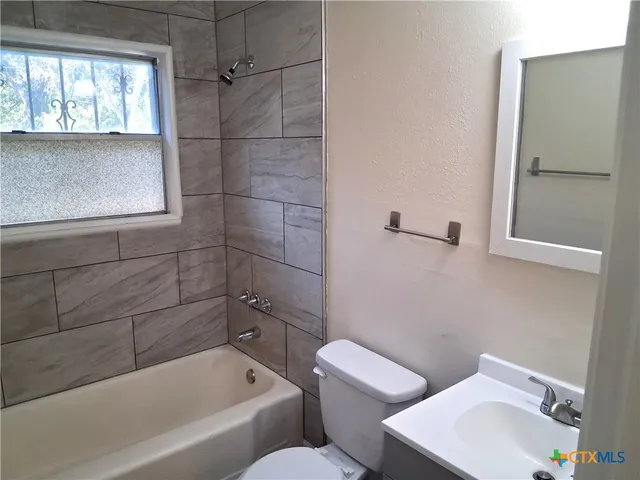 a bathroom with a toilet sink and bathtub