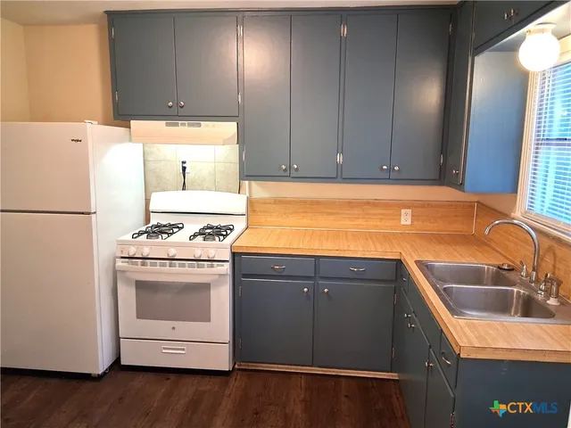 a kitchen with a sink cabinets and stainless steel appliances