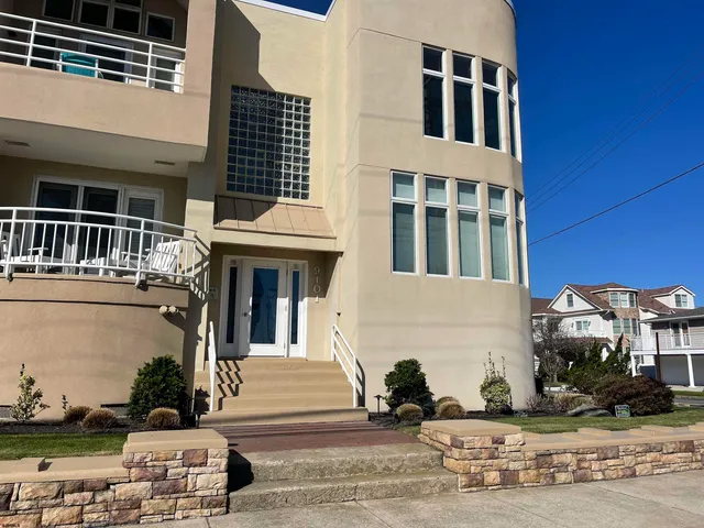 a front view of a building with a yard