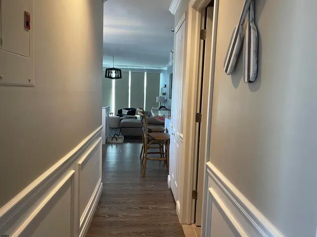 a view of a hallway with wooden floor and staircase