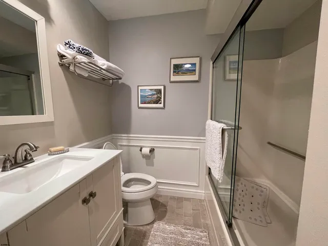 a bathroom with a sink mirror vanity and toilet