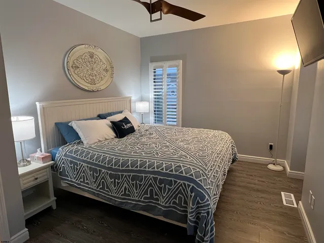 a bedroom with a bed a window and a chandelier