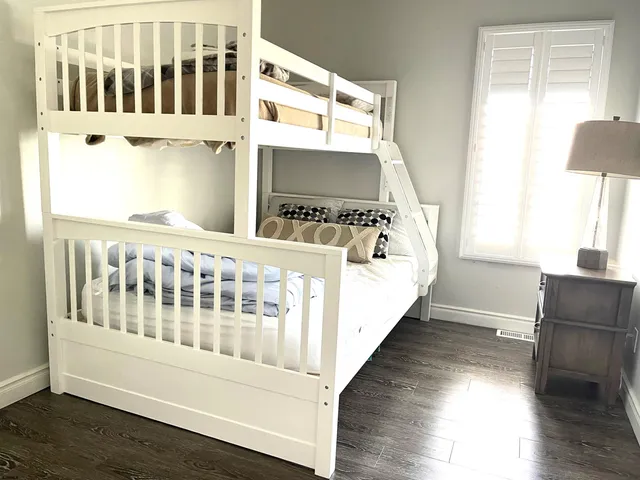 a view of a bedroom with wooden floor