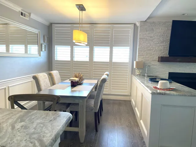 a view of a dining room with furniture and window