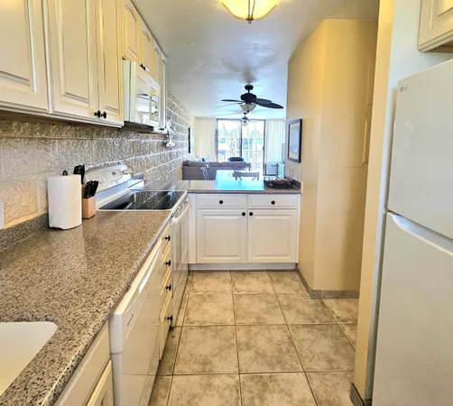 a kitchen with a sink a stove and cabinets