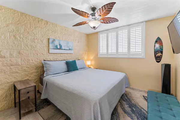 a bedroom with a bed and a painting on the wall