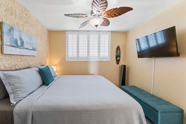 a bedroom with a bed and a flat screen tv