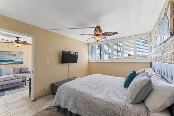 a bedroom with a large bed and a chandelier