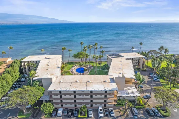an aerial view of a house with an ocean view