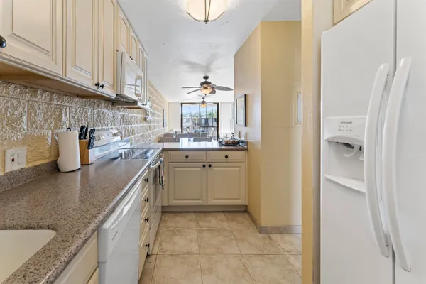 a kitchen with a sink cabinets and a window