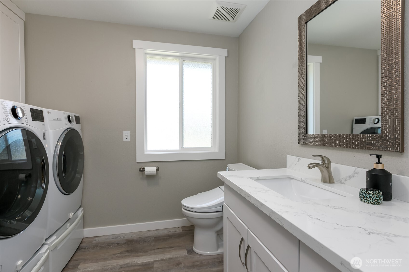 971 Sandy Point Road Langley, WA 98260 - Photo 13 of 35 a bathroom with a sink a washer and dryer