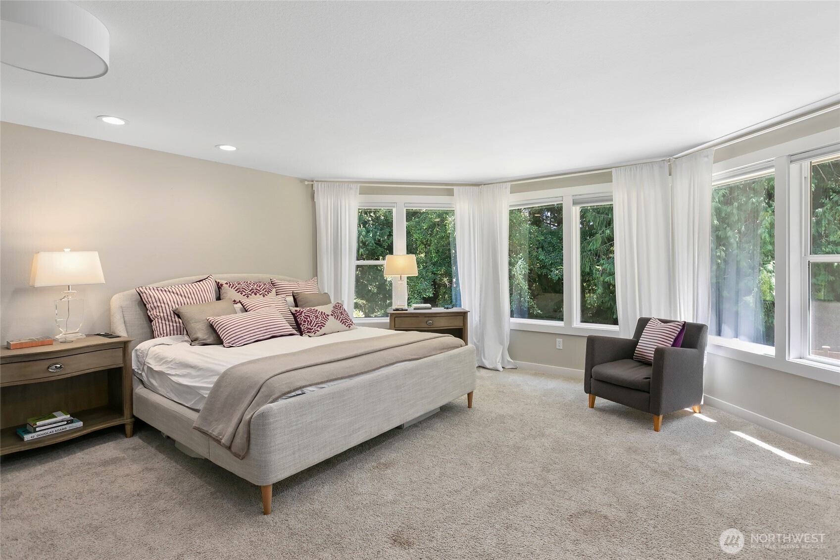 971 Sandy Point Road Langley, WA 98260 - Photo 14 of 35 a spacious bedroom with a bed and a couch next to a window