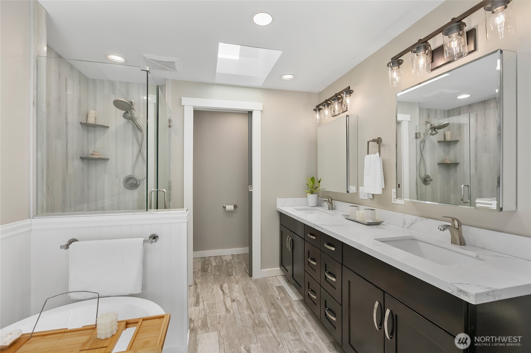 971 Sandy Point Road Langley, WA 98260 - Photo 15 of 35 a bathroom with a granite countertop sink toilet a large mirror a shower and bathtub
