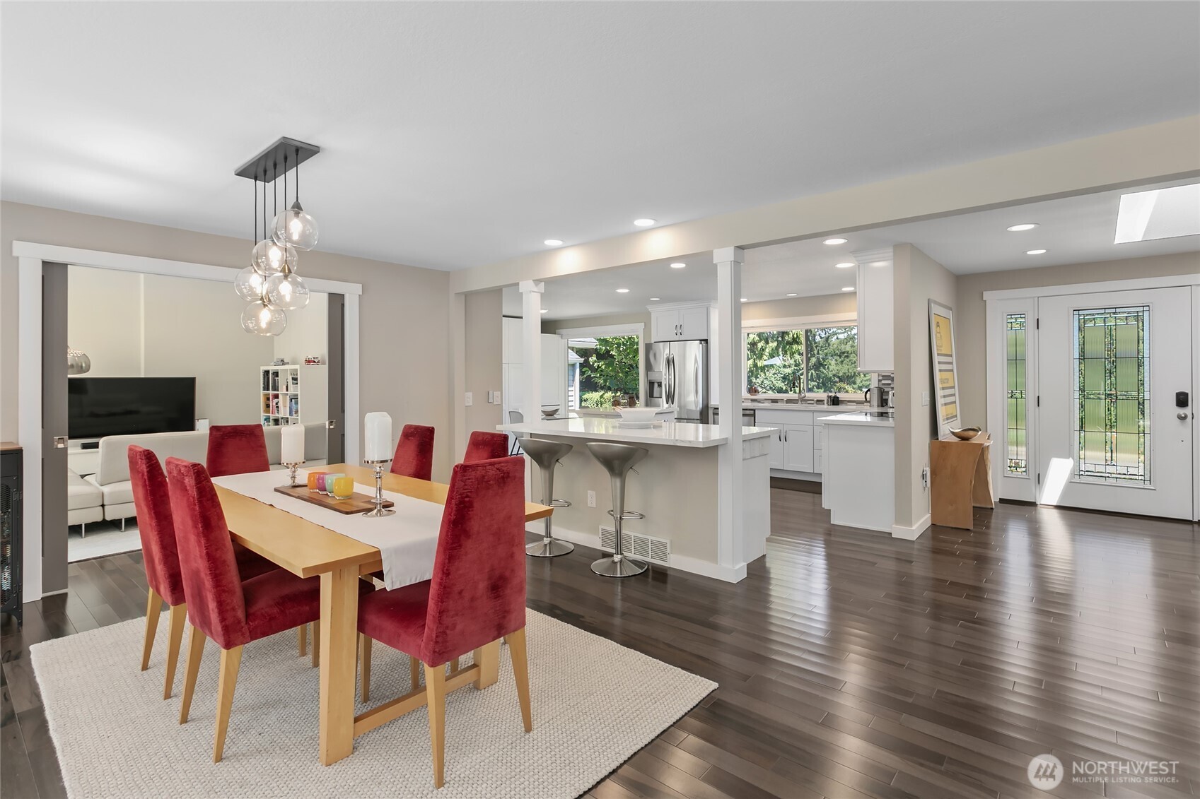 971 Sandy Point Road Langley, WA 98260 - Photo 3 of 35 a dining area with a table chairs and kitchen view