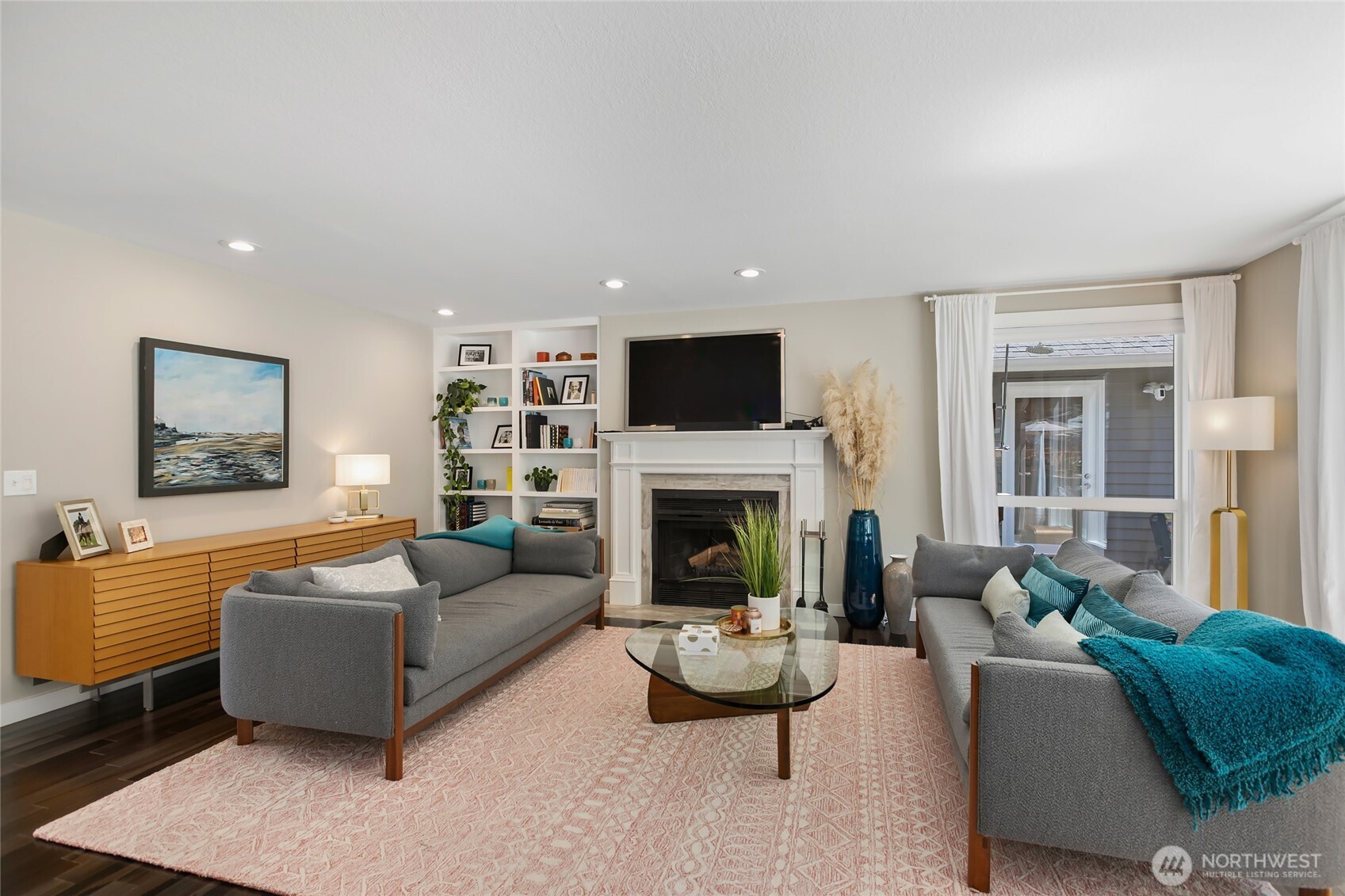 971 Sandy Point Road Langley, WA 98260 - Photo 10 of 35 a living room with furniture a fireplace and a flat screen tv