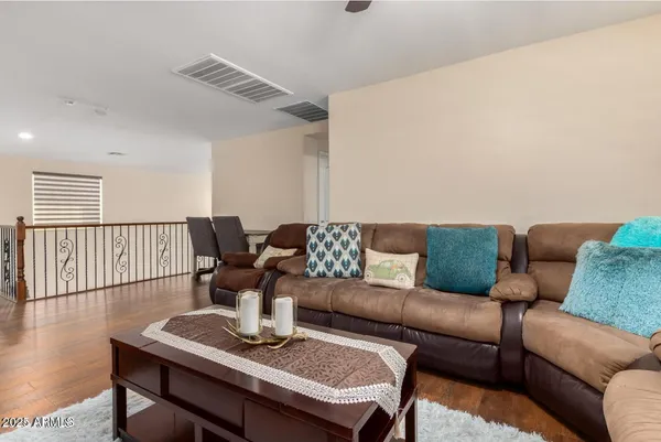 a living room with furniture a wooden floor and a window