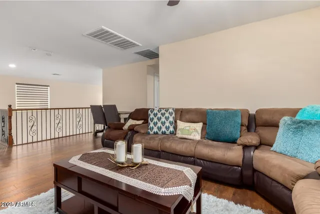 a living room with furniture a wooden floor and a window