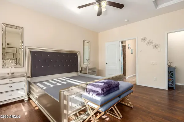 a spacious bedroom with a bed and a chandelier