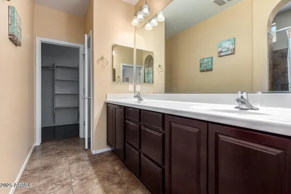 a bathroom with a double vanity sink and a mirror