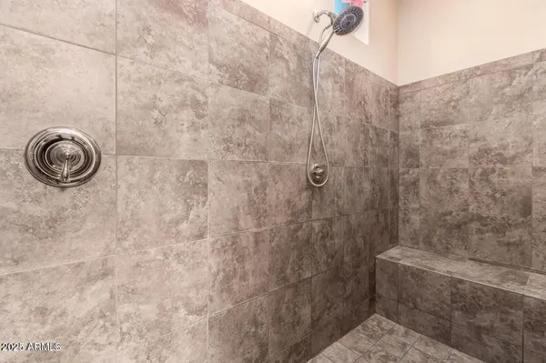 a bathroom with a granite countertop shower and a sink