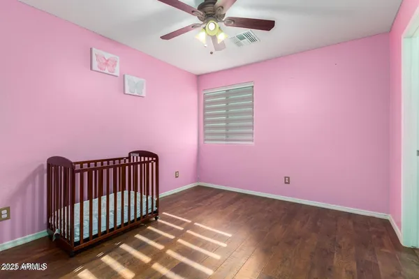 a view of livingroom with hardwood floor and a ceiling fan